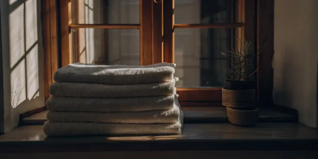 Clean towels folded on windowsill.