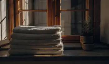 Clean towels folded on windowsill.