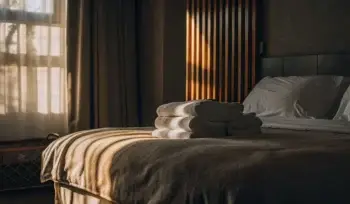 Clean comforter on a neatly made bed. Comforter cleaning services in East Norwich.