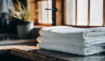 Clean, folded white towels. Dix Hills towel laundry service.