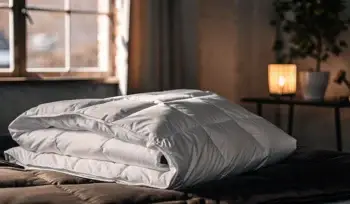 Clean, white comforter on a made bed.