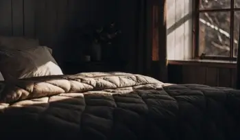 Clean comforter on a made bed.