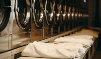 Clean, folded linens in industrial laundry facility. East Williston medical laundry.