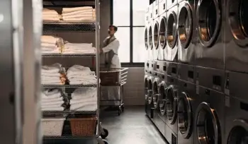 Clean, folded linens in a Hauppauge medical laundry facility.