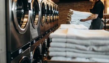 Clean medical laundry folded and stacked in Babylon facility.