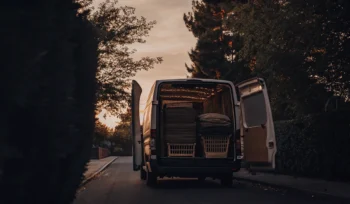 Oyster Bay Cove laundry pickup van delivering baskets of freshly washed clothes.