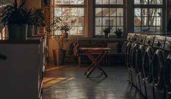 A clean, modern interior of one of the best laundromats in Roslyn with rows of washing machines.