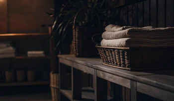 Freshly cleaned comforters in a basket at a professional Center Island cleaning service.