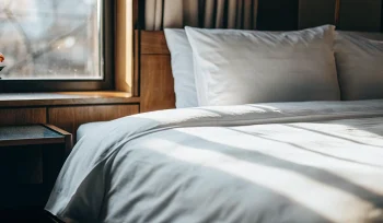 A pristine comforter on a bed after professional cleaning in Sea Cliff.